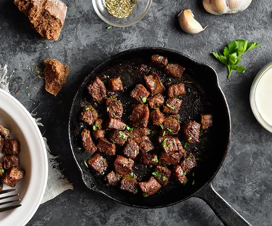 Seared beef cubes cast iron garlic herbs